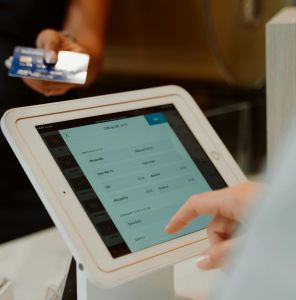 A modern cashless payment system using a tablet and card for seamless transactions.